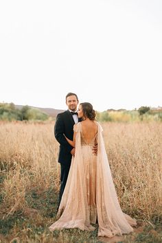 a man and woman standing next to each other in a field with the caption that reads