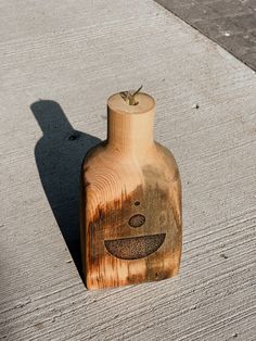 a wooden bottle with a face drawn on it