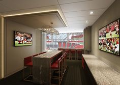 an empty sports bar with red chairs and pictures on the wall