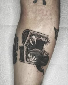 a black and white photo of a person's leg with a tattoo on it