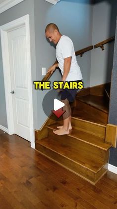 a man is walking up the stairs in his house to get out of the door