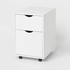 a white cabinet with two drawers sitting on top of it's legs and one drawer open