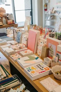 the table is full of cards and stationery on it's sides, along with other items