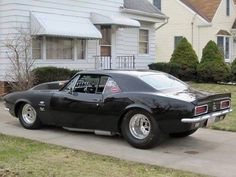 a black car parked in front of a house