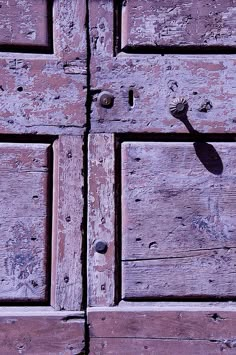 an old wooden door with nails on it