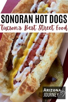 a close up of a hot dog on a bun with toppings and the words sonoran hot dogs