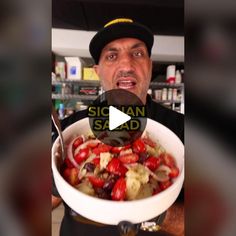 a man is holding a bowl full of food with the words sicilian salad in front of him