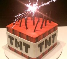 a birthday cake with sparklers in the shape of letters that spell out tht