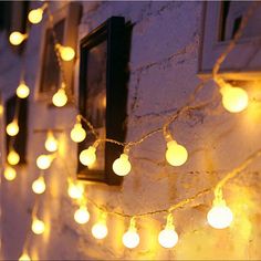 some lights are hanging on the side of a building and there is no image here to provide a caption for