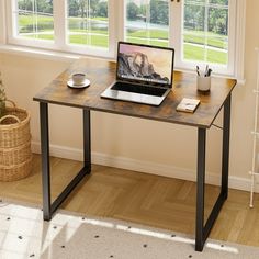 a laptop computer sitting on top of a wooden desk in front of two large windows