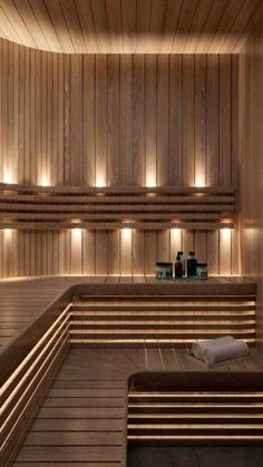 a sauna room with wooden walls and benches