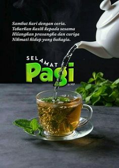 tea being poured into a glass cup on top of a saucer with mint leaves