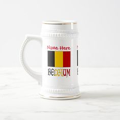 a beer mug with the name here and belgium on it coffee mugs are designed to look like flags