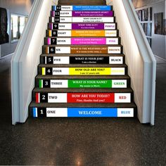 there is a staircase with many signs on the riser and handrails that are painted in different colors