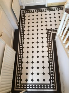 a black and white tiled floor with stairs