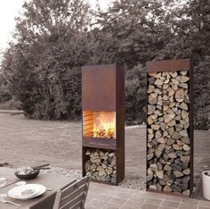 an outdoor fire pit with logs in it