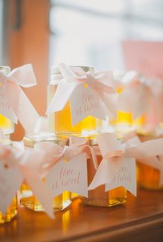 small jars filled with honey sitting on top of a table