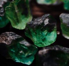 some green crystals are sitting on the ground