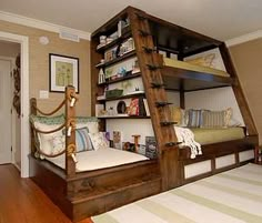 a bunk bed in the corner of a room with a ladder on it's side