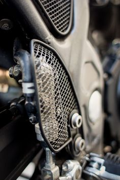 the front end of a motorcycle with metal mesh