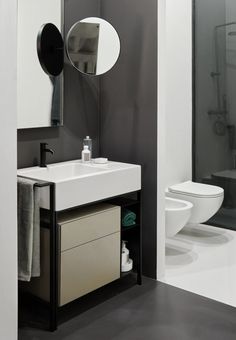 a bathroom with a sink, toilet and shower in it's stall area next to a walk - in shower