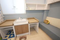 a small bathroom with a teddy bear rug on the floor next to it's sink