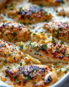 chicken and pasta casserole in a white dish with parsley sprinkled on top