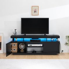 a flat screen tv sitting on top of a black entertainment center