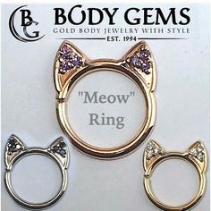 two gold tone cat ear rings with purple crystal eyes and ears on each one side