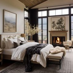 a bedroom with a large bed and fireplace in the corner, surrounded by windows that look out onto mountains