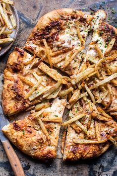 a pizza topped with lots of french fries