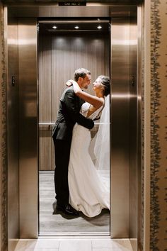 a bride and groom kissing in an elevator