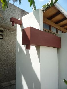 the corner of a white building with red trim