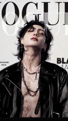 a woman with tattoos on her chest wearing a black leather jacket and silver necklaces