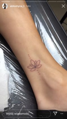 a woman's foot with a flower tattoo on it