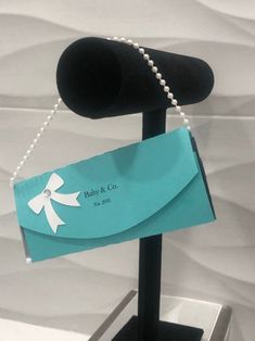 a close up of a business card on a stand with a chain attached to it