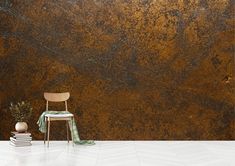 a chair sitting on top of a white floor next to a wall covered in rust