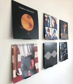 the wall is decorated with four different album covers