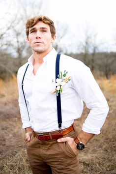 a man with suspenders and a flower in his lapel