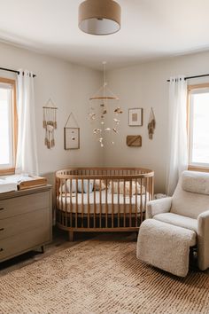 a baby's room with a crib, rocking chair and dresser in it