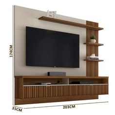 an entertainment center with shelves and a flat screen tv mounted on the wall above it