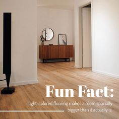 a living room with wood floors and white walls has the words fun fact light - colored flooring makes a room especially bigger than it actually is