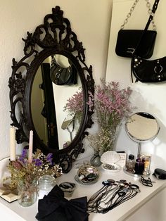 a mirror and some flowers on a table