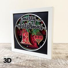 a christmas card in a white frame on a wooden surface with the words merry christmas