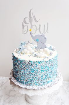 a blue and white cake with an elephant on top