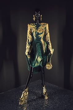 a mannequin dressed in green and gold