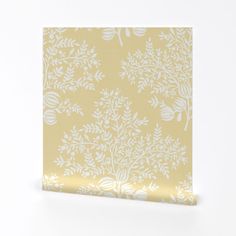 a yellow and white wallpaper with small leaves on the bottom half of it, against a white background