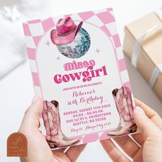 a person holding up a pink and white card with a cowgirl design on it