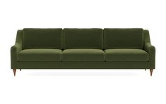 a green couch sitting on top of a white floor