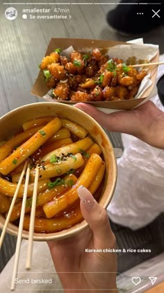 a person holding a bowl of food with chopsticks in it and another hand holding a container full of food